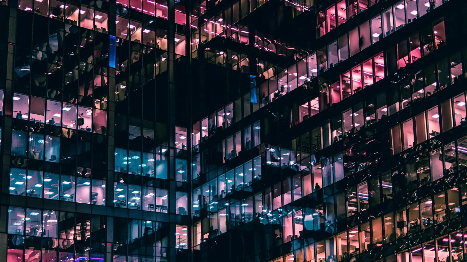 Modern office building illuminated at night representing innovation and technology